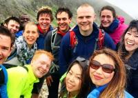 A group of happy hikers in the Lake District smiling at the camera
