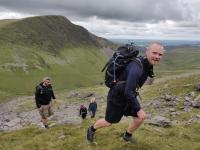 Brave Dave leading people up a valley in Snowdonia