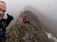 Brave Dave gives a thumbs up whilst his client waves at the camera on Crib Goch